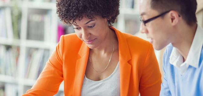 Two work colleagues mixed race working together