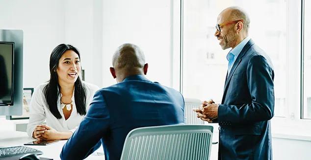 Two business professionals meeting with a retirement plan specialist