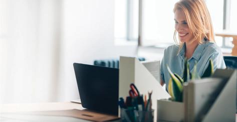 Beautiful businesswoman sitting at her ofice and smiling.