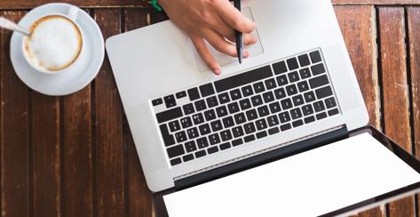 Woman's hand using computer on desk 