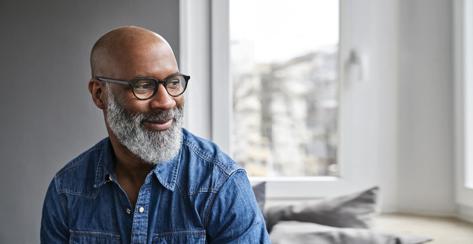 African American mature man smiling sitting at home relaxing 