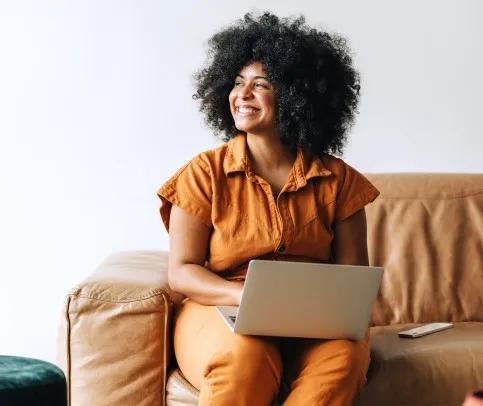 Smiling woman holding a laptop