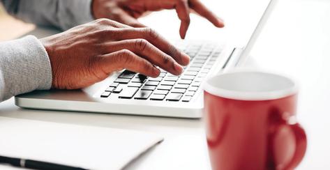 Businessman using laptop at work for internet research on startup technology