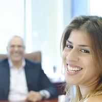 Coworkers sitting in an office and smiling