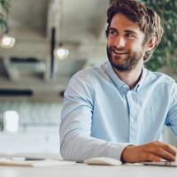 Businessman in shirt working on his laptop in an office. Open space office