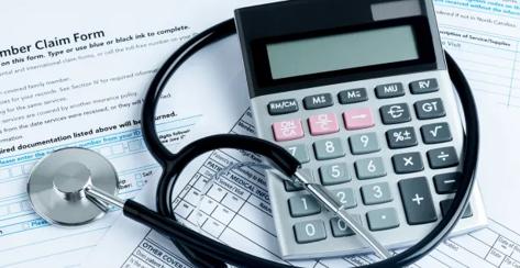 Stethoscope wrapped around a calculator.