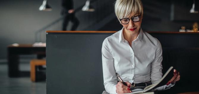 Portrait of an elegant businesswoman writing notes