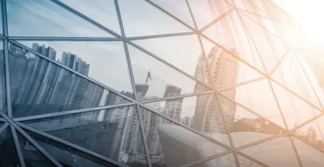 Domed glass showing a reflection of city buildings