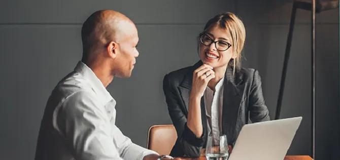 A male financial professional working with a female client