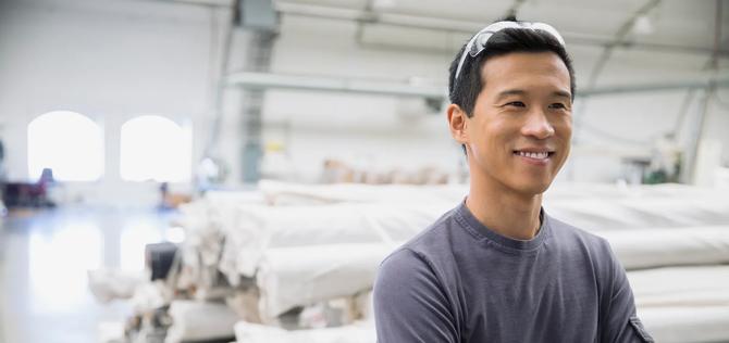 Confident worker in textile manufacturing plant