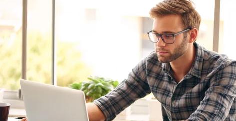 A man looking at a laptop.