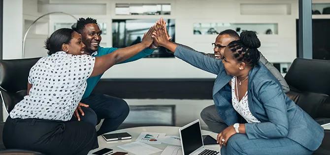 Friendly successful all african business team give high five together in office, excited happy employees celebrating corporate victory, african workers teambuilding concept