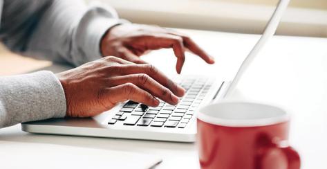Businessman using laptop at work for internet research on startup technology