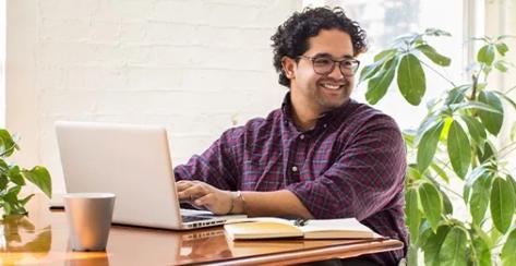 A young man in a wheelchair reviewing his financial information