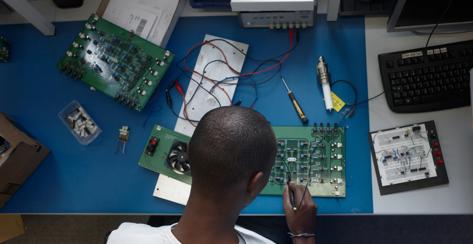 Birdseye view of African American electroncis engineer at workbench