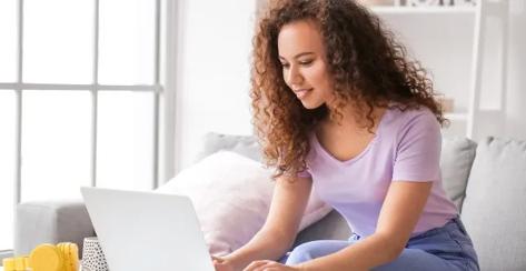 Young woman looking at her laptop.