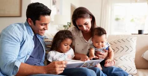 Family reading a children's book.