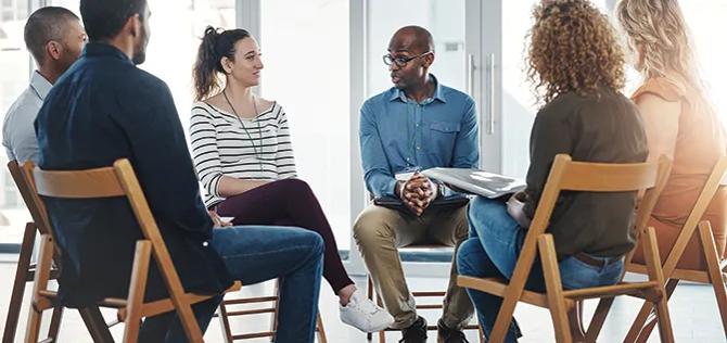 People sitting in a circle talking about their mental health issues and looking for support, help and counseling