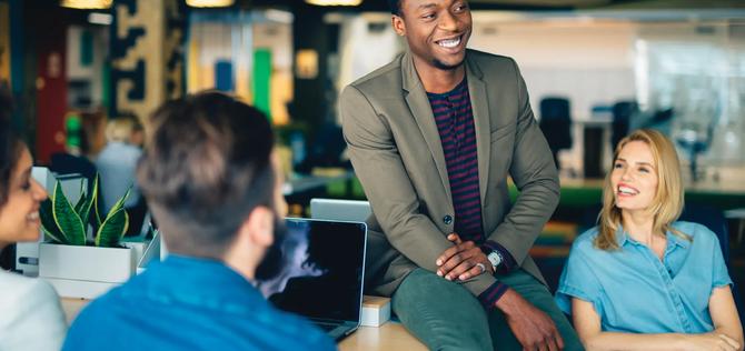 Businessman chatting in the office and smiling.
