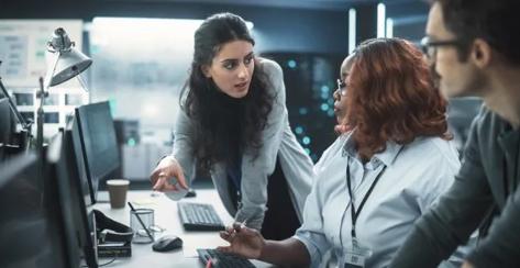 3 employees reviewing computer screen,