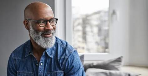 African American mature man smiling sitting at home relaxing