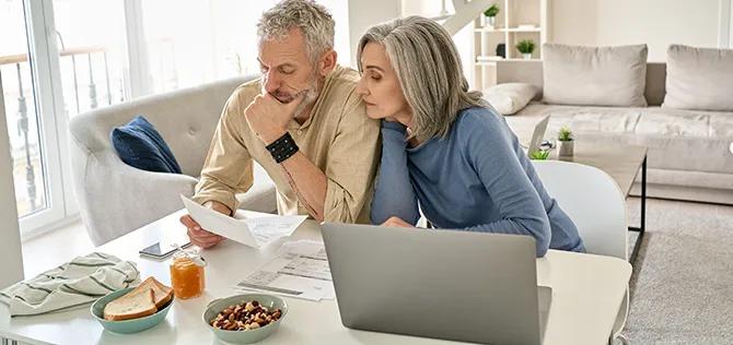 Serious retired couple planning retirement finances