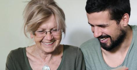 Mother and adult son looking at a photo book