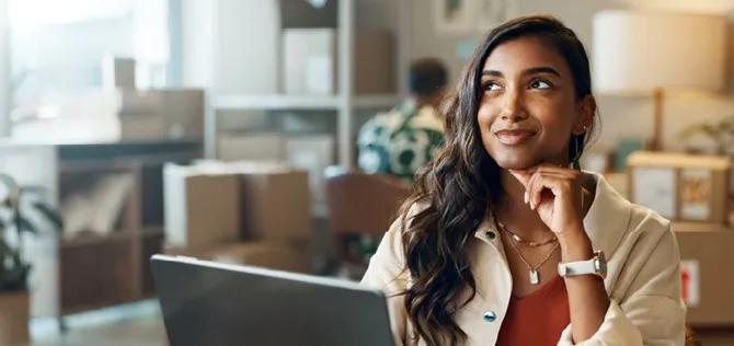 woman at computer looking thoughtful