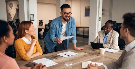 Office team collaborating during an engaging meeting. The group discusses strategies, encouraging teamwork and innovation in a professional environment.