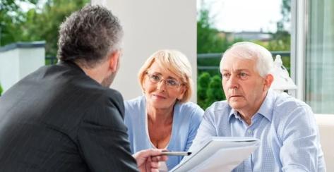 Older Caucasian couple meeting with their financial professional 