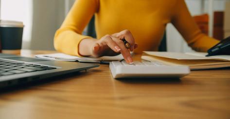 Young woman small business owner online shopping at home. taking note of orders from customers with mobile phones. SME entrepreneur or freelance life style concept.