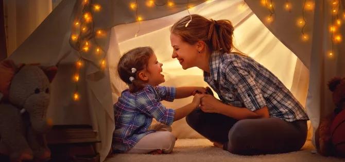 woman with daughter in a tent