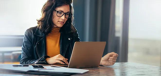 Business woman working on a laptop in a professional office