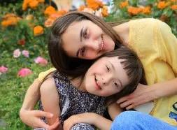 Woman and child smiling and hugging