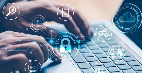 Cybersecurity professional working on a laptop.