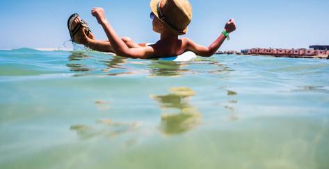 Mari boy floating in inflatable ring in ocean