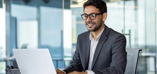Businessman in glasses on laptop computer
