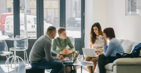 Young people gathered with computers in coffee shop