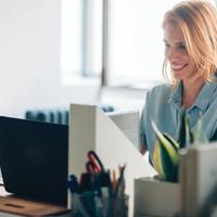 Beautiful businesswoman sitting at her ofice and smiling.