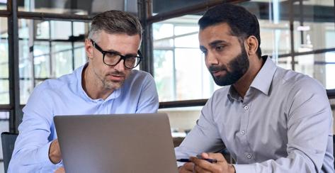 two men looking at laptop