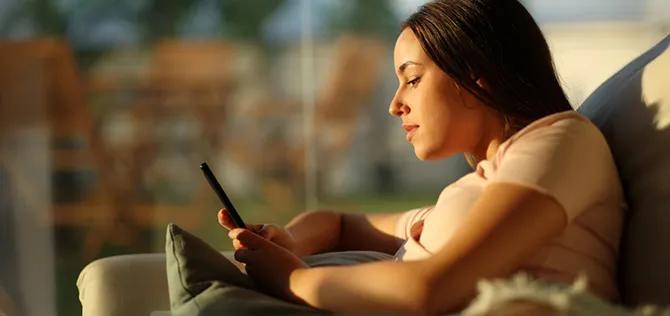Woman using mobile phone at home