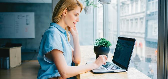 Beautiful businesswoman sitting  and working on a laptop.