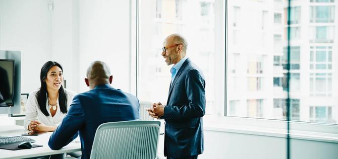 Business colleagues discussing project in office conference room