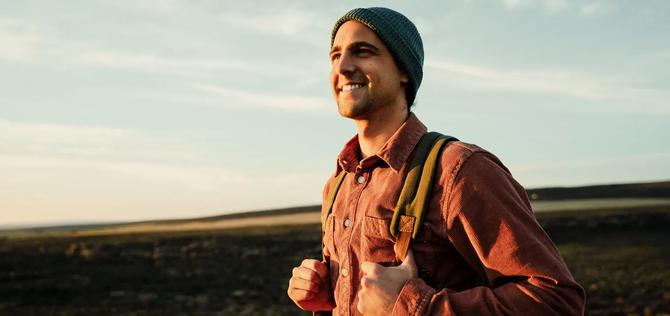 Man smiling while hiking.